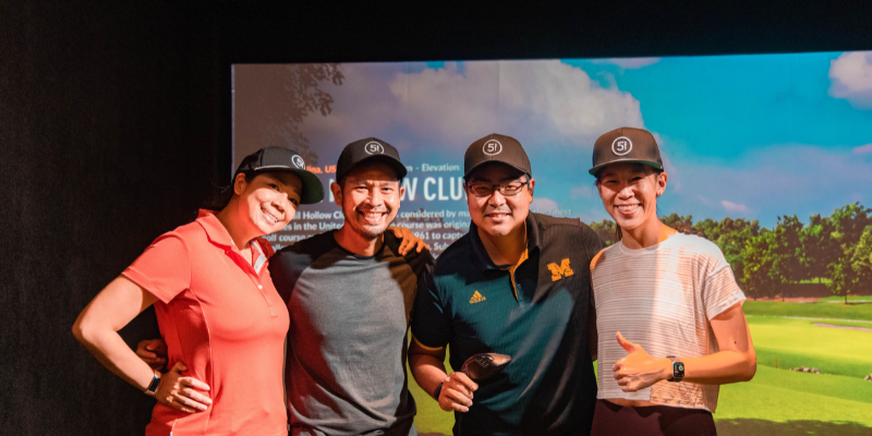 Five Iron Golf Four People Playing Golf