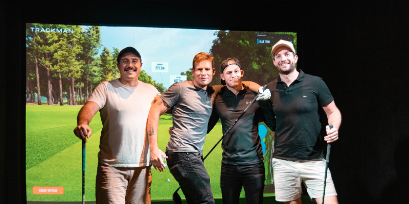 Five Iron Golf Four People Playing Indoor Golf
